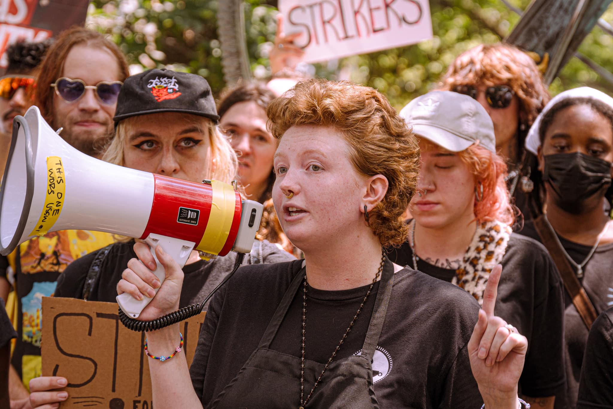 a group of folks standing behind a person with a megaphone